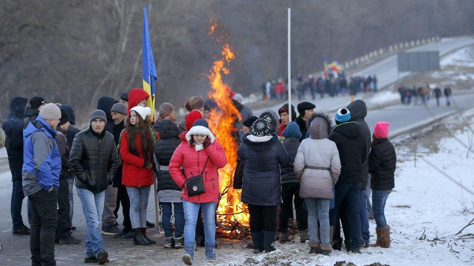 Protesters against the new government in Chisinau block a main road