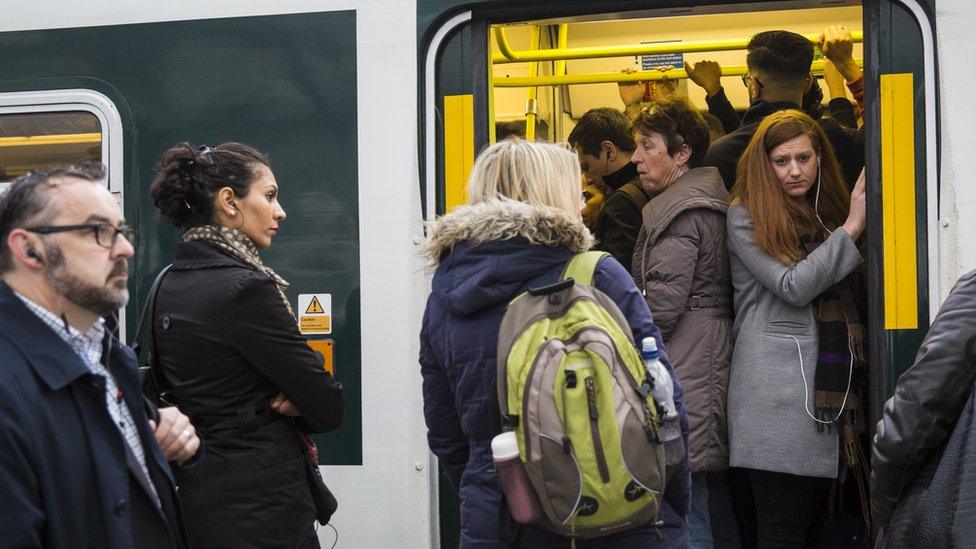 Commuters packed on to a Southern rail train wait to leave East Croydon station