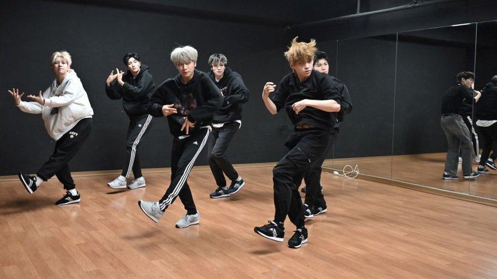 A K-pop group practice in a dance studio in Seoul