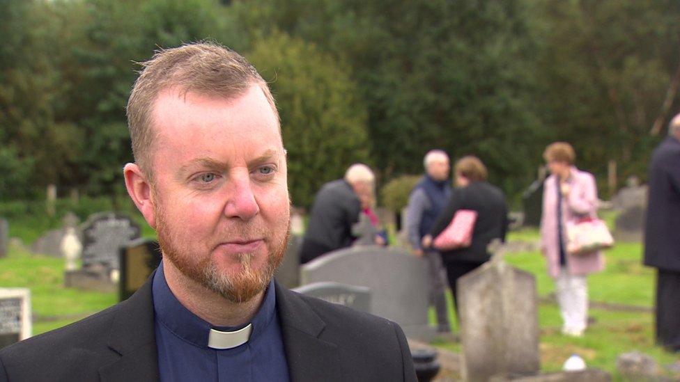 Reverend Richard Houston standing in Milltown Cemetery Belfast.