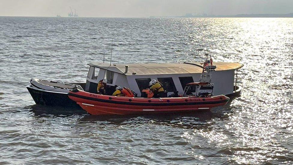 The sinking trawler and a life boat