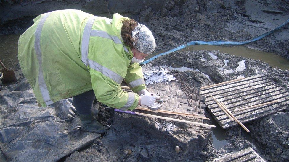 Archaeologist recovering items