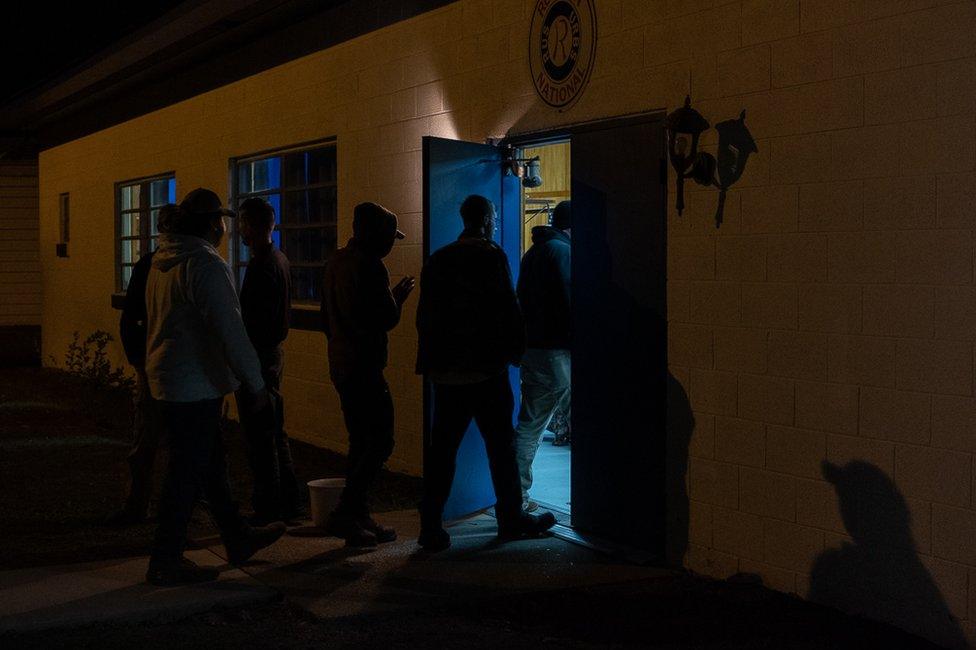 Militia members arriving at a meeting in a Virginia suburb, ahead of a gun rally the following day