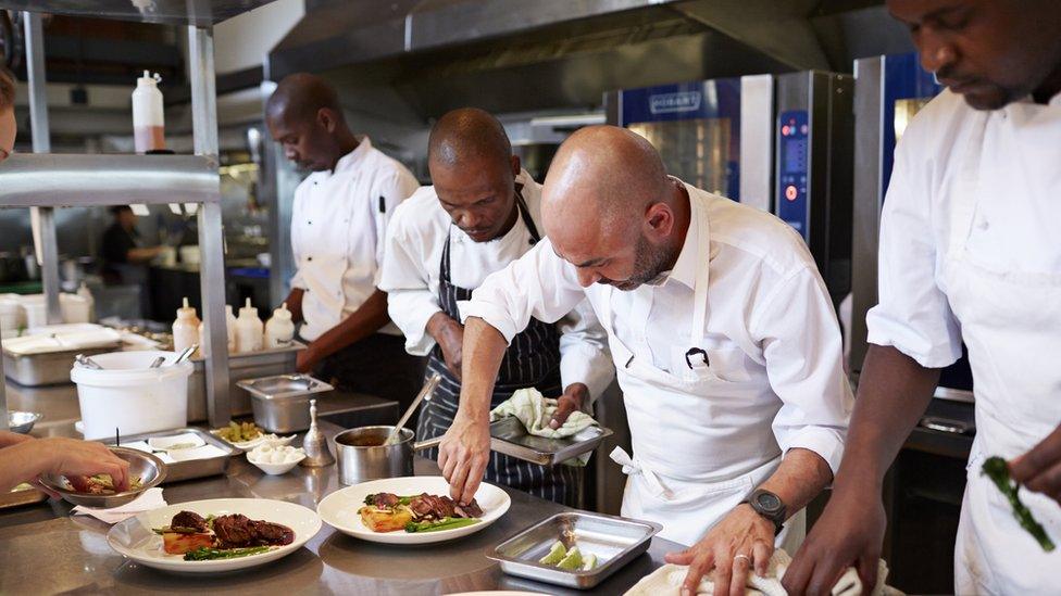 Chefs at work in kitchen