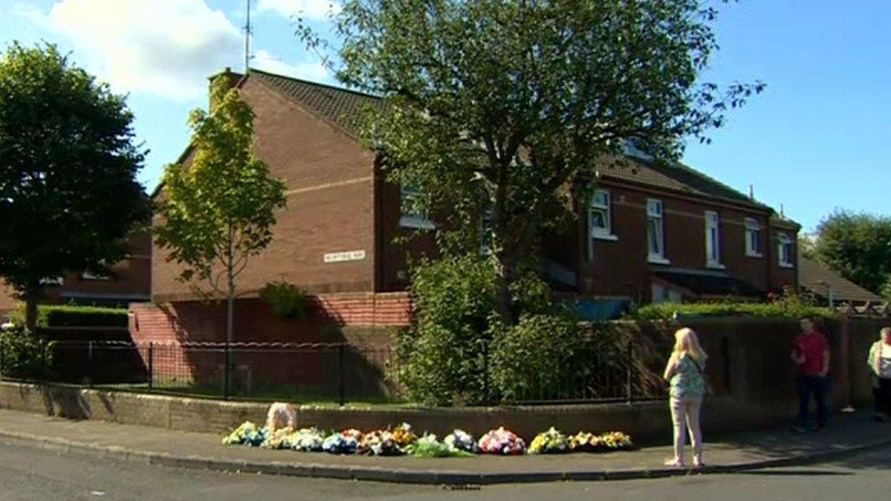 Flowers were left outside Mr McGuigan's home at Comber Court in the Short Strand