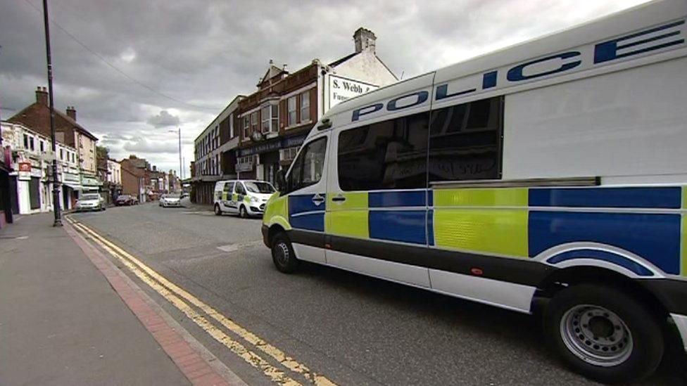 Police vehicles on road