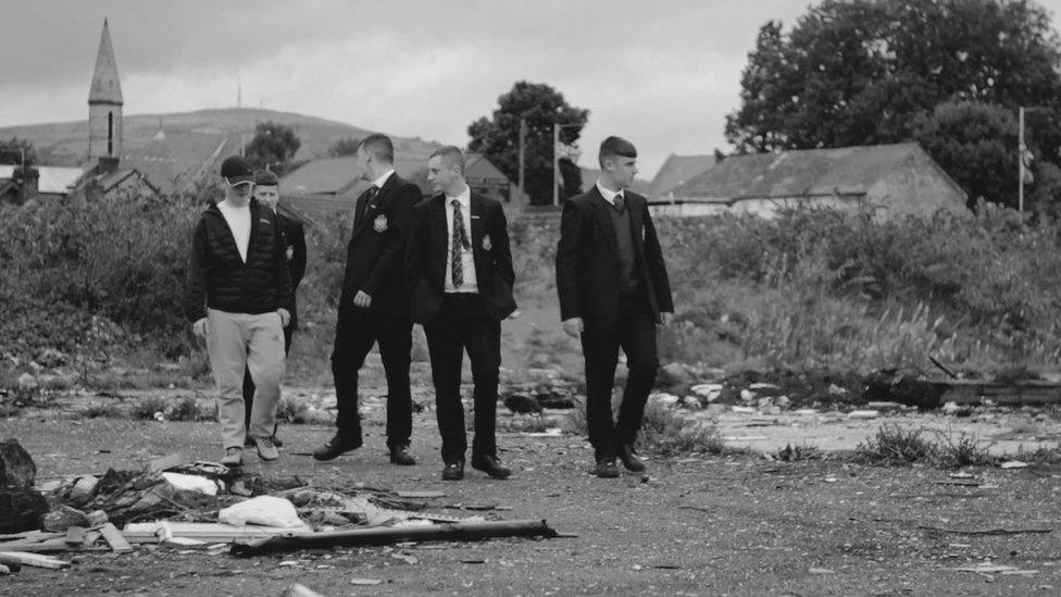 School boys in field with rubbish scattered