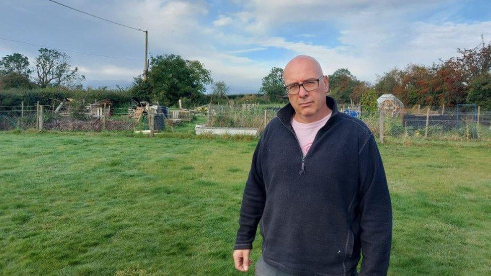 Photo of Mr Plummer standing in front of land at centre of dispute