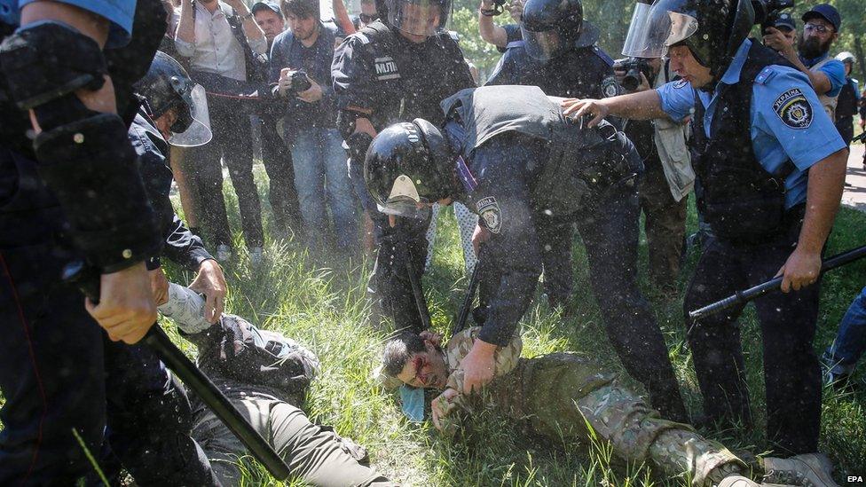 Policemen detain anti-gay protesters during the Gay pride parade in Kiev