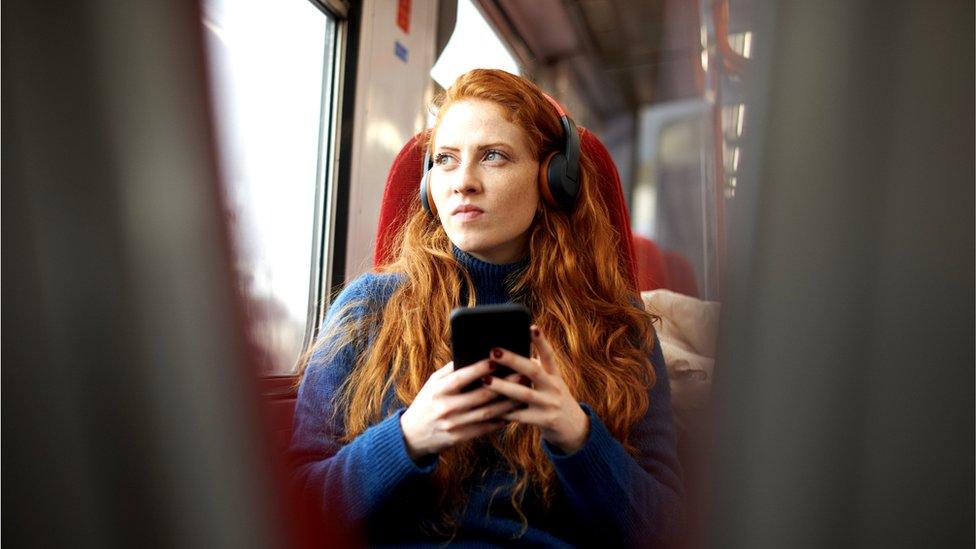 Woman looking concerned on train