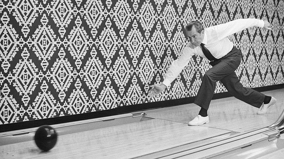 President Nixon releases a bowling ball at Executive Office Building lanes