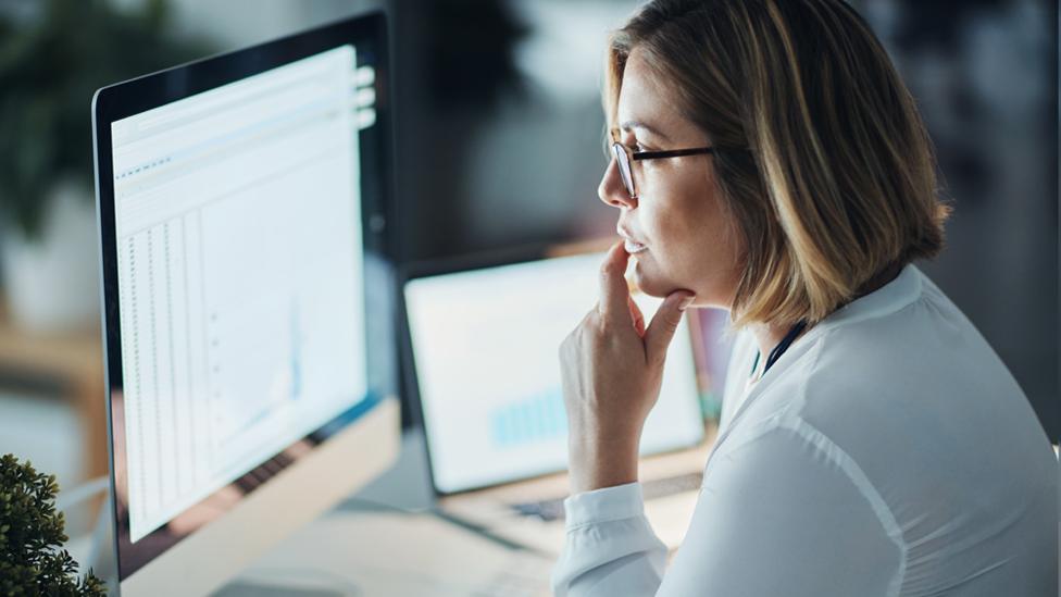 Stock image of a woman working at a computer