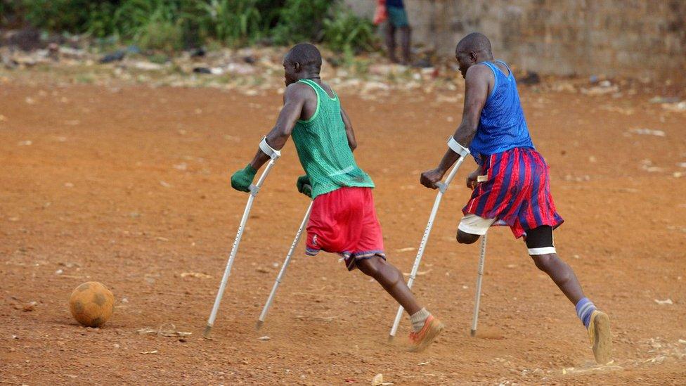 Two amputees playing football