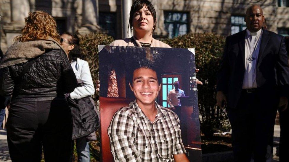 Sister-in-law, Fiona Paez, holds a photograph of environmental activist Manuel Teran