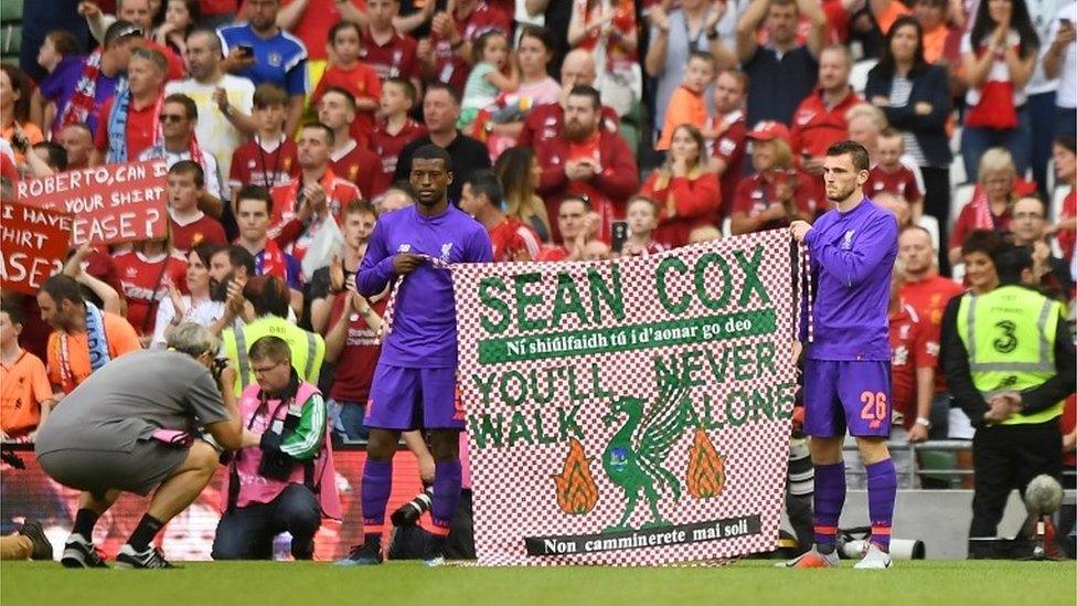 Pre Season Friendly - Napoli v Liverpool - Aviva Stadium, Dublin, Ireland - August 4, 2018 Liverpool"s Georginio Wijnaldum and Andrew Robertson hold up a banner in support of Liverpool fan Sean Cox after the match