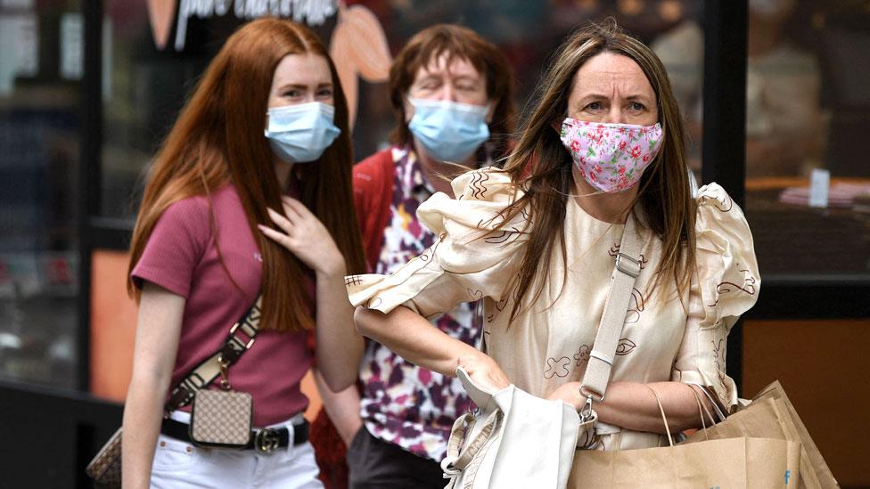 Shoppers wearing masks