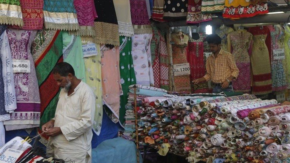 Vendors work as they wait for customers at a garment store in a market in Mumbai, India, February 4, 201