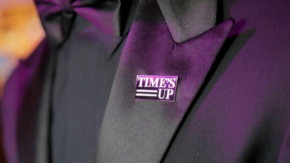 Joe Jonas wearing a Time's Up pin