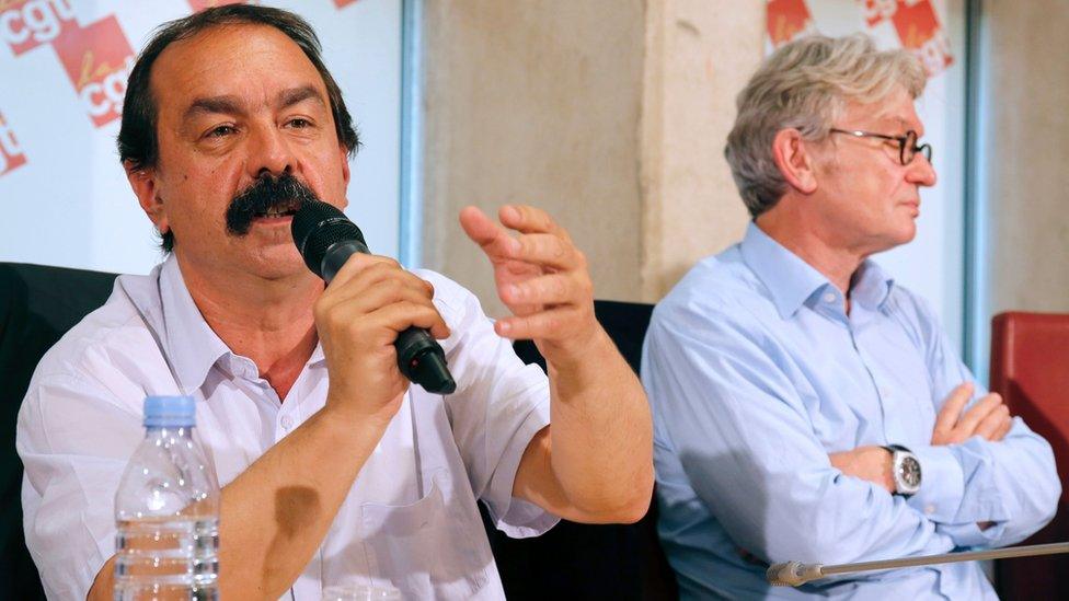 Secretary-general of the French General Confederation of Labour (CGT), Philippe Martinez (L), flanked by Secretary-general of the French workers' union Force Ouvriere (FO), Jean-Claude Mailly (R), speaks to journalists during a press conference on 22 June 2016 in Paris