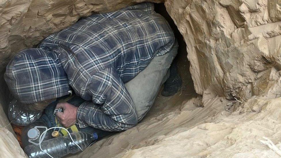 A protester in a hole at Chertsey