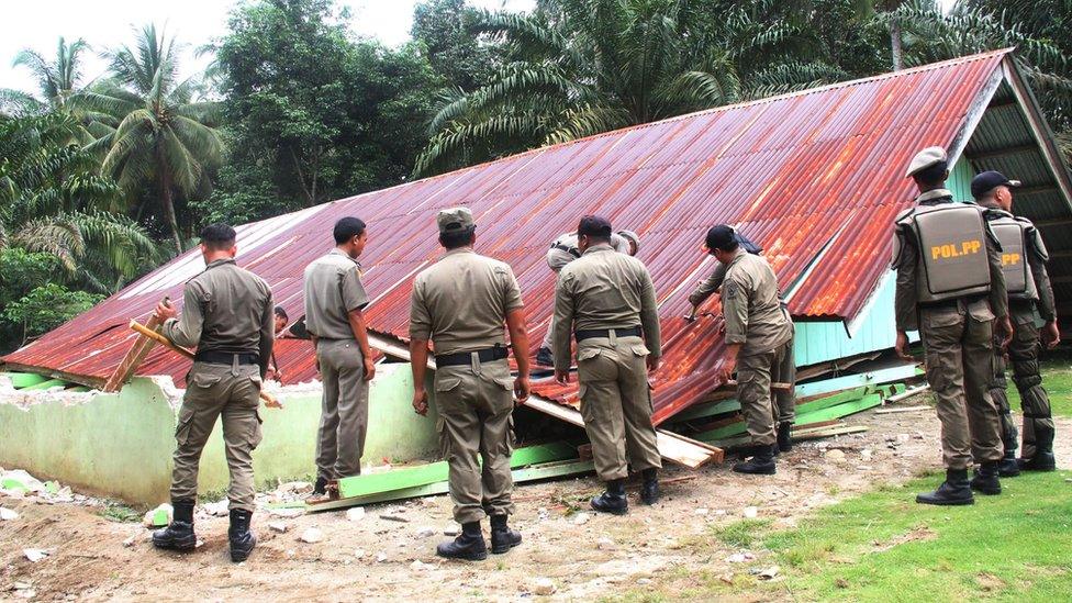 Indonesian officials tear down a church during the demolition of several churches by the local government in Singkil, Aceh province 19 October 2015