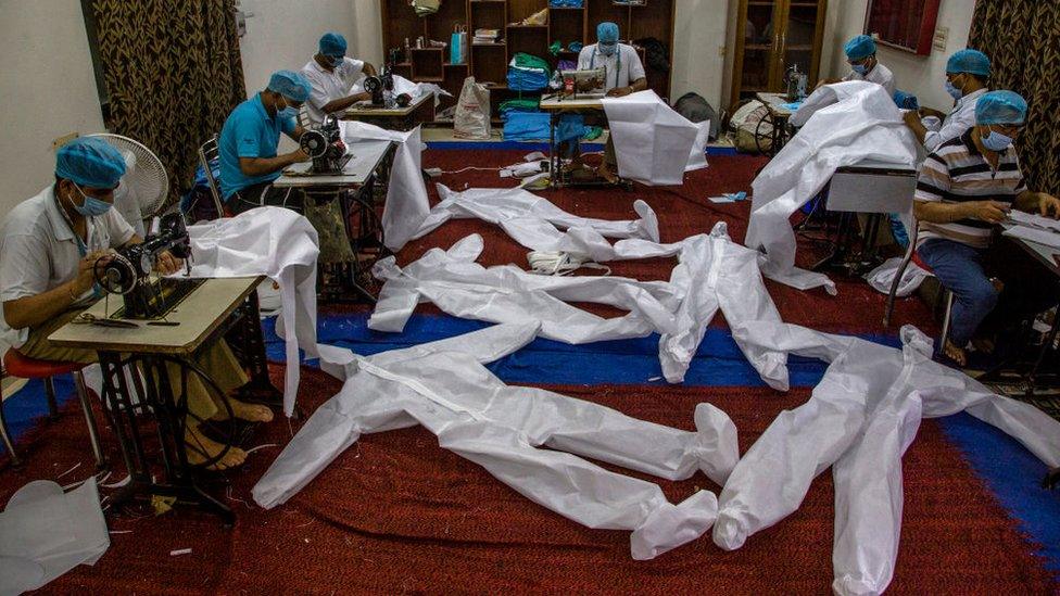 Indian paramilitary soldiers from the Central Reserve Police Force manufacture Personal Protective Equipment (PPE) suits at their camp.