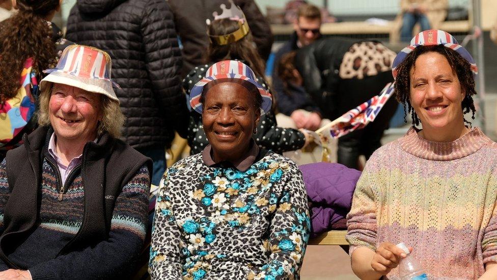 Three women wearing plastic union Jack hats in Newcastle's Times Square