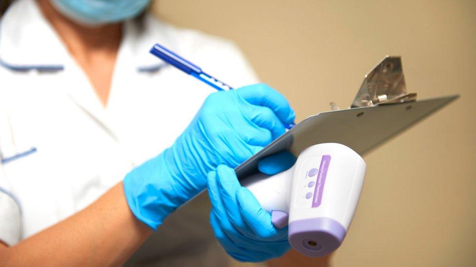 A nurse with a clipboard