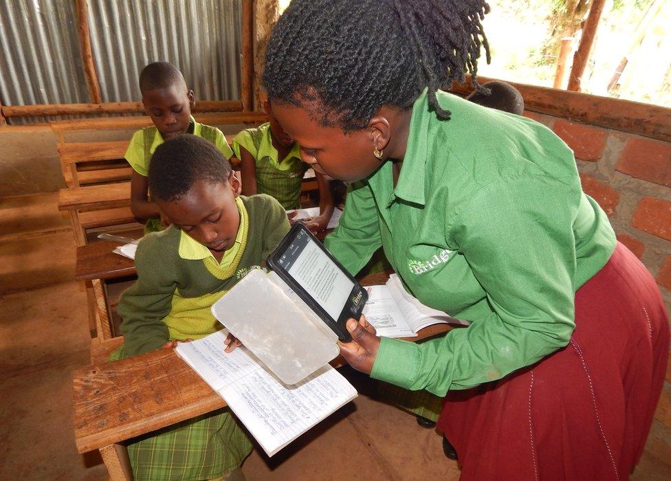 A teacher interacts with a student at a Bridge International school