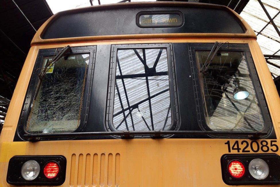 A smashed front window on a train