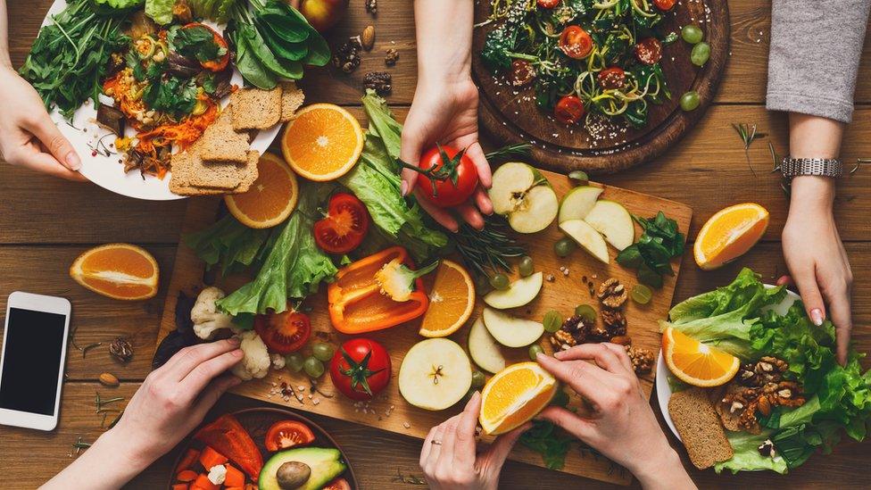 Four friends share a vegan meal