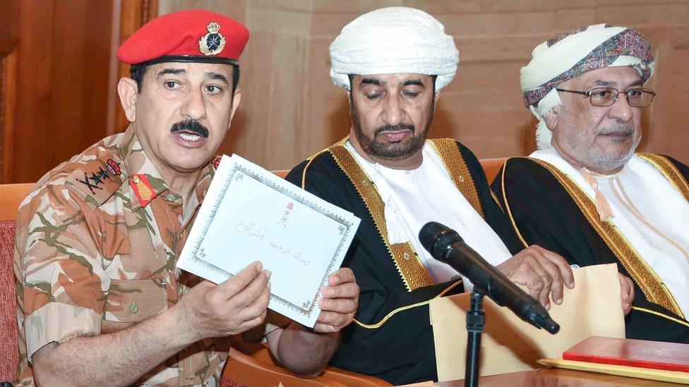 General Sultan bin Mohammed al Nomani (L) shows a letter from the envelope which contains the will of the late Omani leader Sultan Qaboos in the capital Muscat,