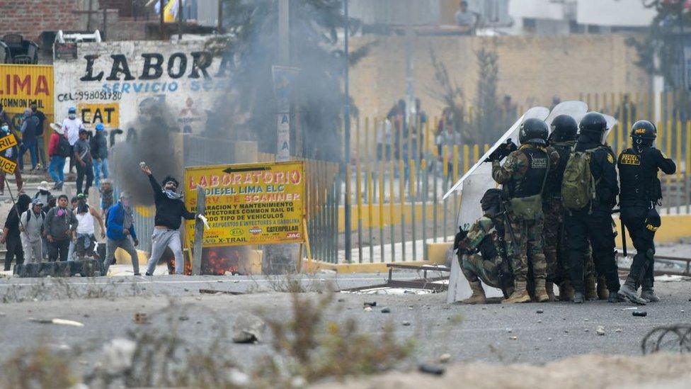 Demonstrators clash with riot police during a protest on the Pan-American highway in the Northern Cone of Arequipa, Peru