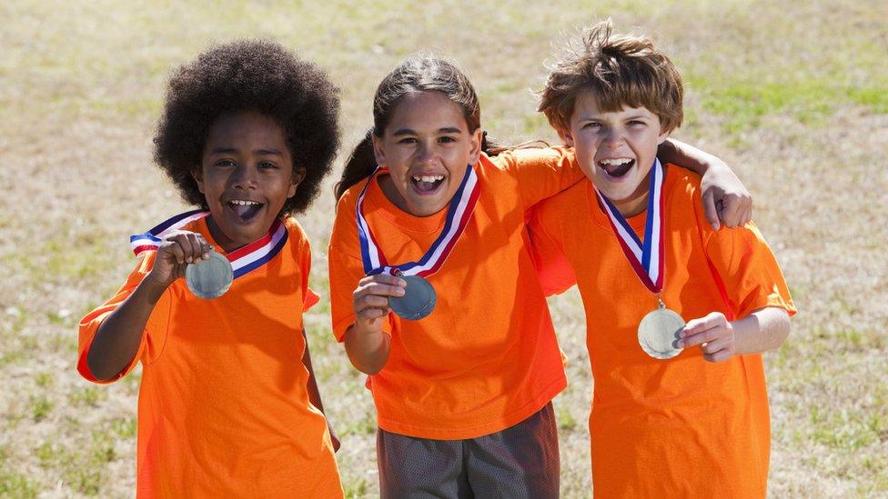 Three boys with medals