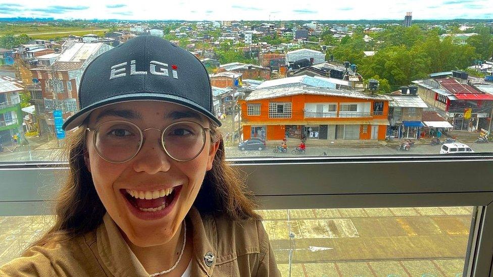 Zara Rutherford in Quibdo in Colombia with colourful buildings in the background