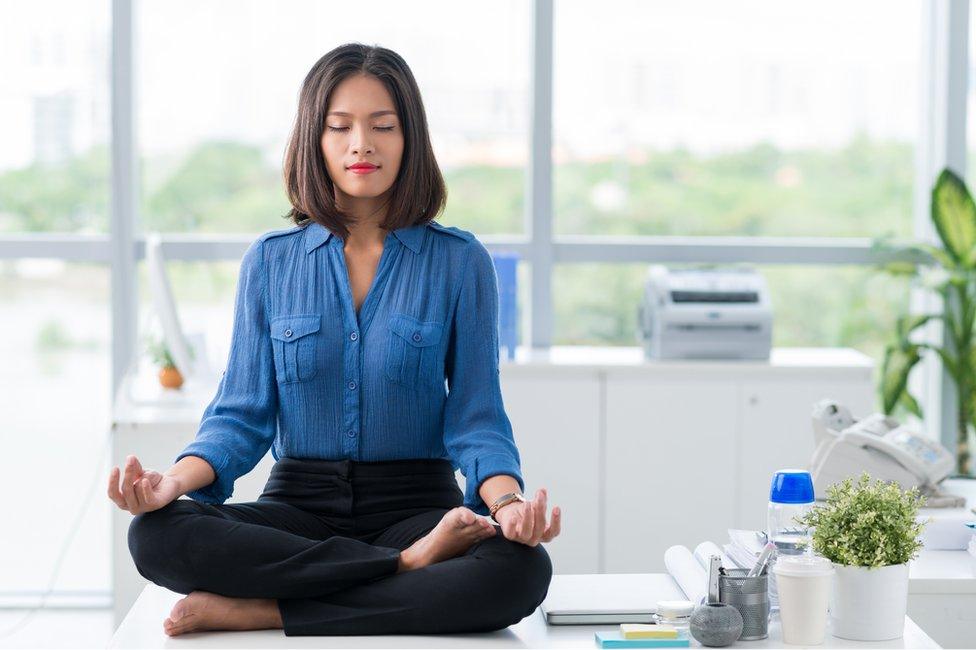 Woman meditating on desk