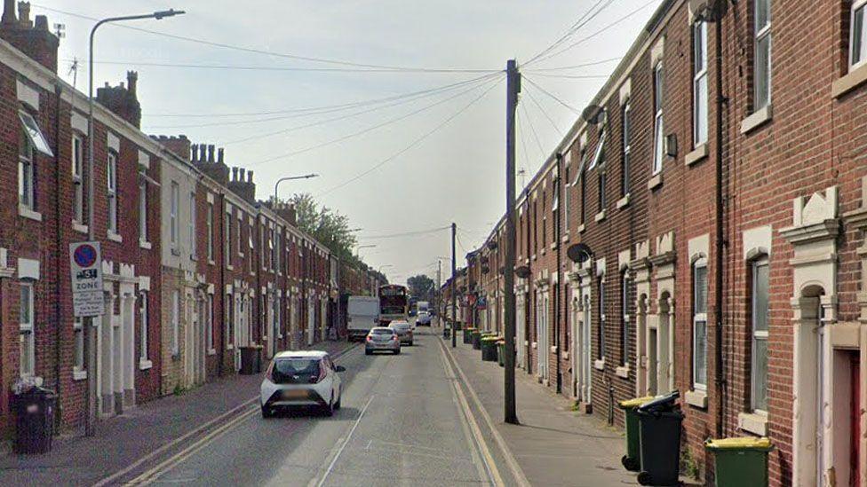 Google Streetview image of Plungington Road, a street in Preston with red-brick terraced houses on either side of a long straight road.