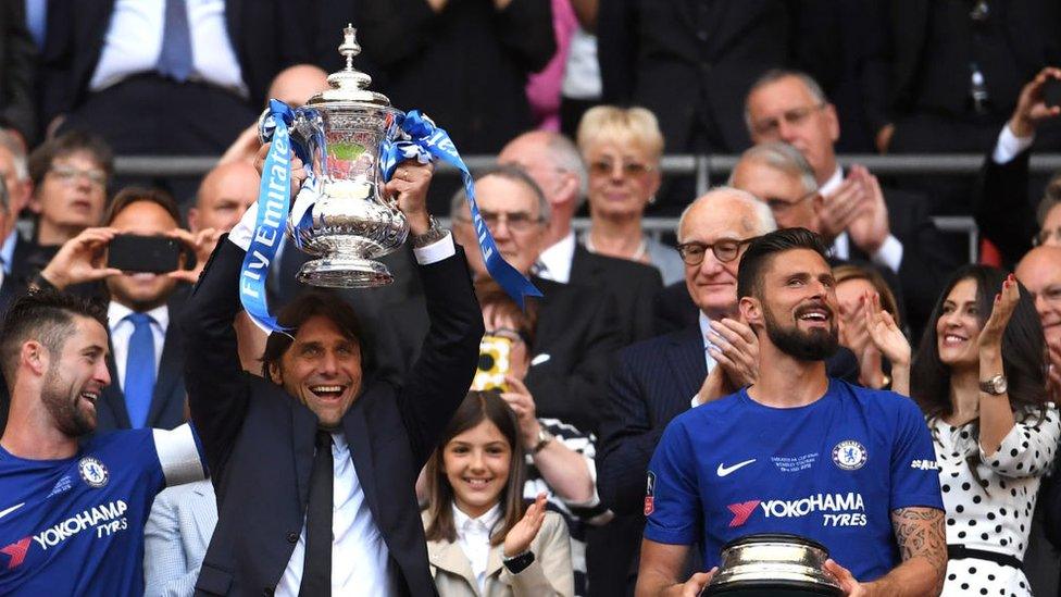 Antonio Conte, Manager of Chelsea lifts the Emirates FA Cup Trophy following his sides victory in The Emirates FA Cup Final between Chelsea and Manchester United at Wembley Stadium on May 19, 2018 in London, England.