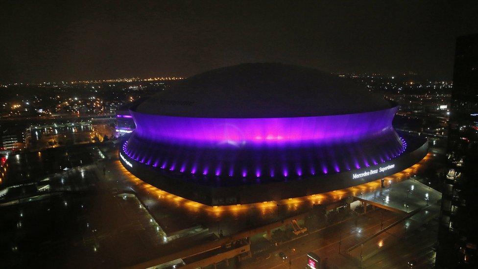 The Mercedes-Benz Superdome is lit up purple in New Orleans