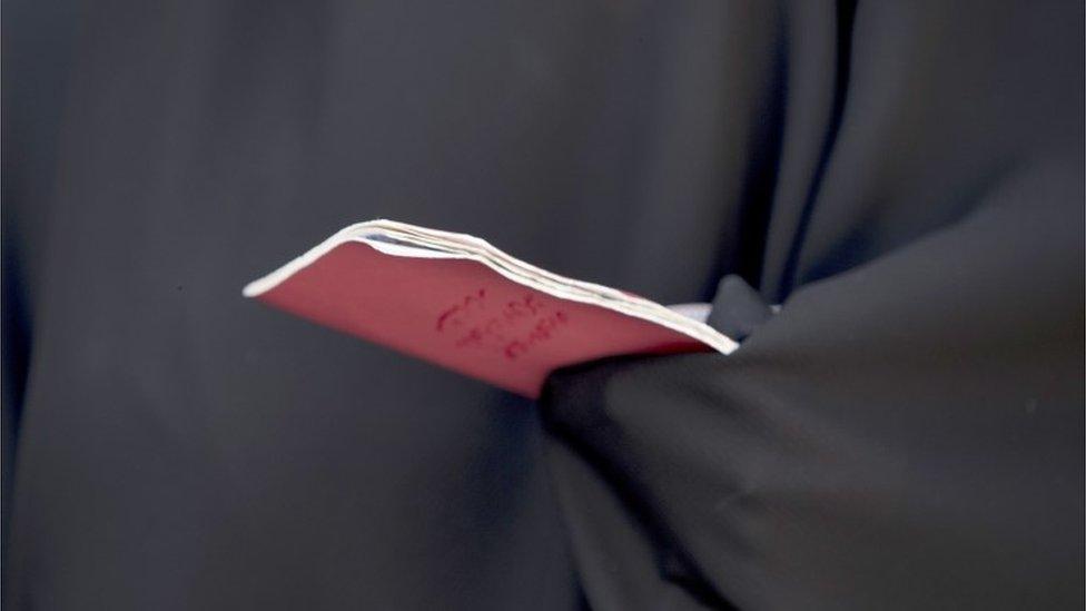 A voting card held by a woman in an abaya - Qom, Iran - 19 May 2017