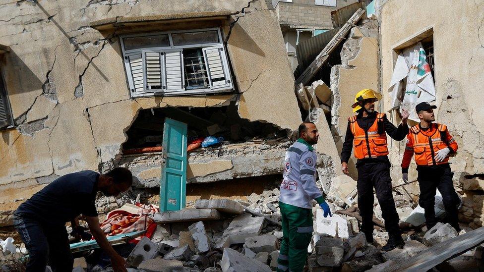 Palestinian rescue workers inspect a house where Palestinian Islamic Jihad commander Ahmed Abu Daqqa was killed, in the southern Gaza Strip (11 May 2023)