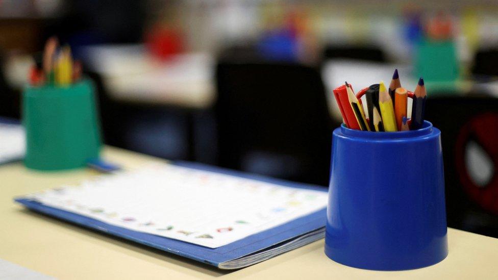 Pencils in holders in an empty classroom