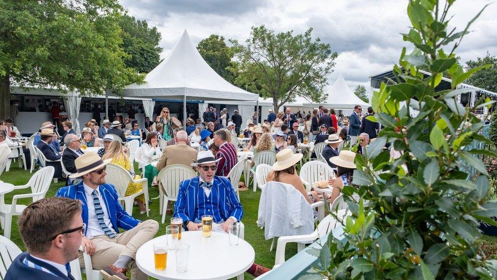 Regatta spectators having drinks