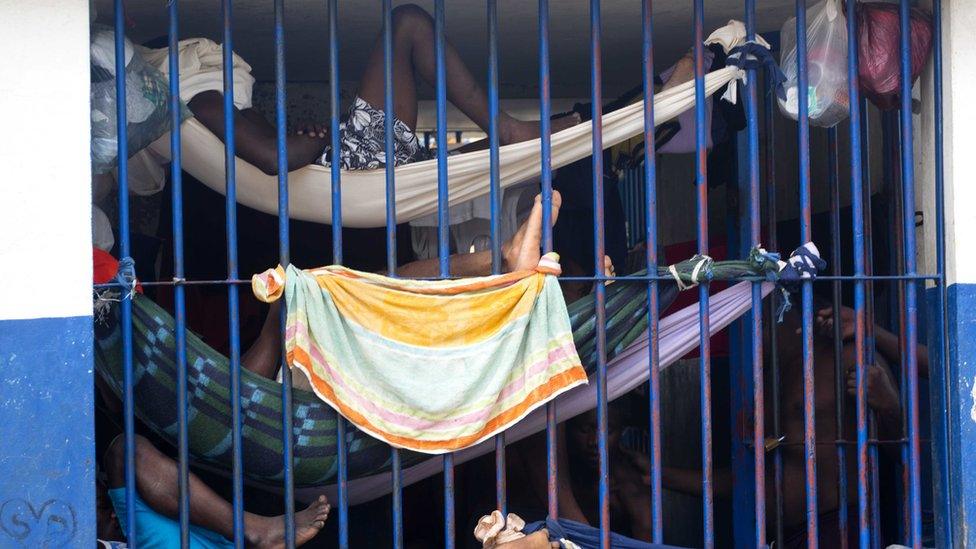 Prisoners rest in makeshift hammocks inside the National Penitentiary in downtown Port-au-Prince