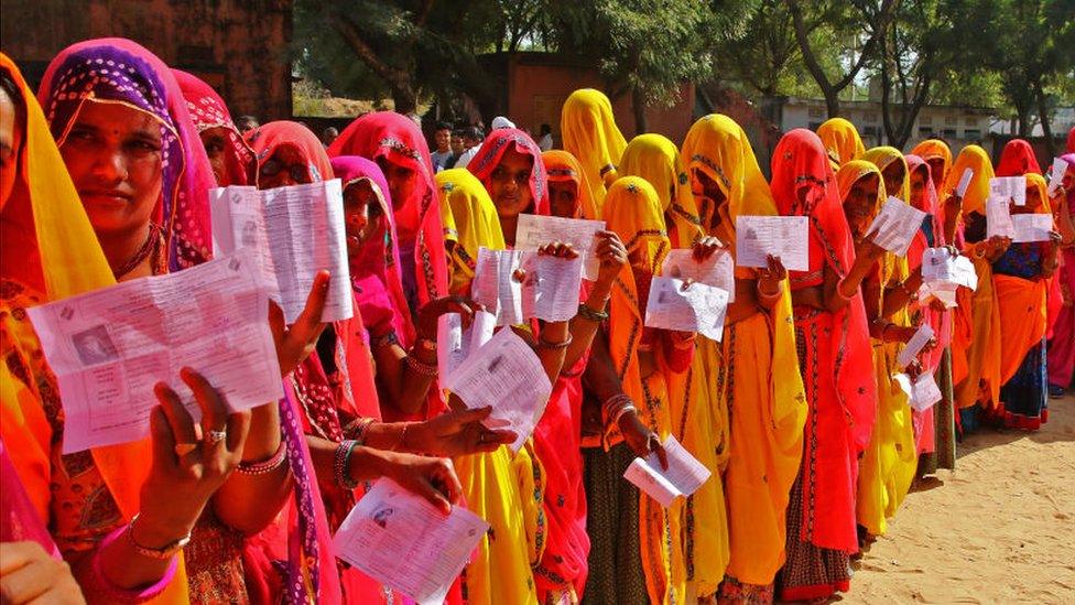 Women queue with their identity cards at the state elections in Rajasthan, December 2018