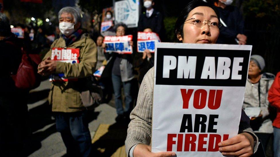 Anti-Abe protesters with banners