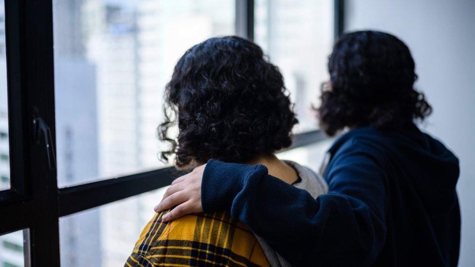 Sisters photographed from behind in Hong Kong