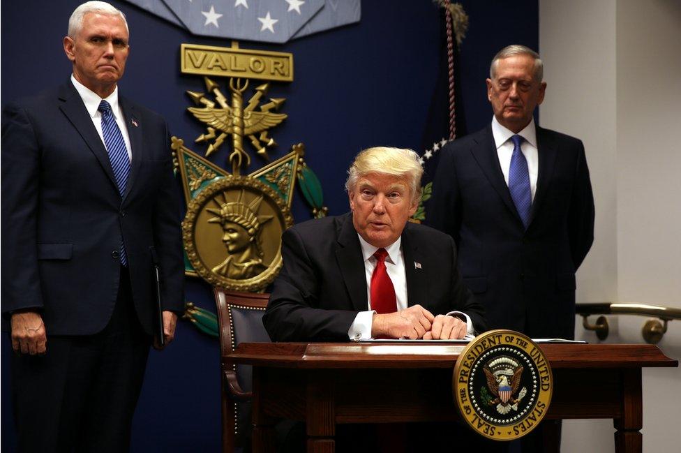 Donald Trump signs an executive order to impose tighter vetting of travellers entering the United States on January 27, 2017.