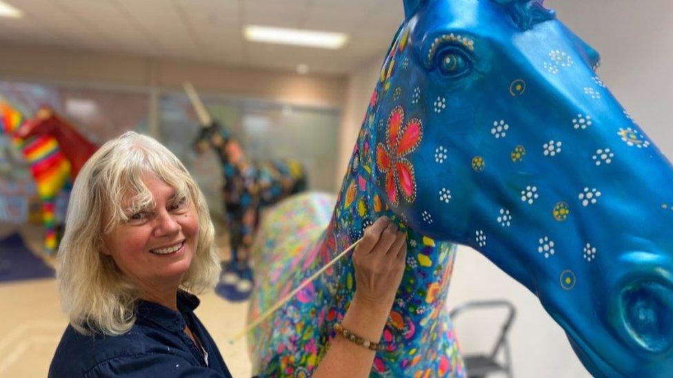 Artist painting a unicorn for Bristol arts trail