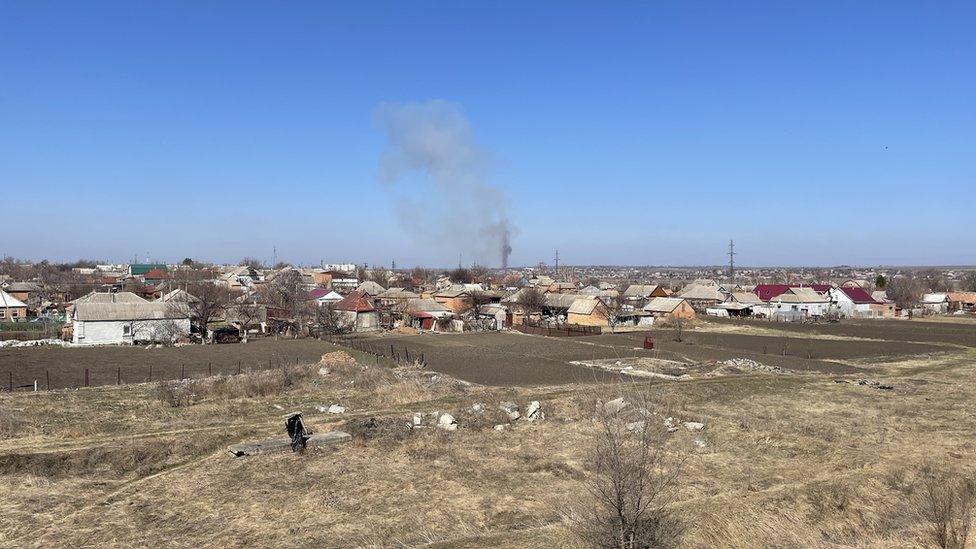 Picture showing flatlands of western Ukraine, with smoke billowing from a rooftop